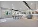 Finished basement with a ping pong table, wet bar, media area, and ample natural light at 10095 S Shadow Hill Dr, Lone Tree, CO 80124