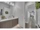 Modern bathroom with a vanity, mirror, and decorative elements with a long hallway at 10095 S Shadow Hill Dr, Lone Tree, CO 80124