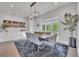 Dining room with a large table, modern chandelier, large window, and built-in cabinets at 10095 S Shadow Hill Dr, Lone Tree, CO 80124