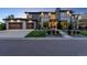 Beautiful modern two-story home featuring a stone and gray facade with a well-manicured front yard and three car garage at 10095 S Shadow Hill Dr, Lone Tree, CO 80124
