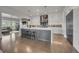 Bright, open kitchen with an island and seating, stainless steel appliances, and an open concept design into the living room at 10095 S Shadow Hill Dr, Lone Tree, CO 80124