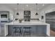 Bright, open kitchen with pendant lights, a large island, stainless steel appliances, and a view into an open living room at 10095 S Shadow Hill Dr, Lone Tree, CO 80124