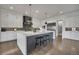 A spacious kitchen features a large island with seating, pendant lighting, and stainless steel appliances at 10095 S Shadow Hill Dr, Lone Tree, CO 80124