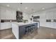 A spacious kitchen features a large island with seating, pendant lighting, and stainless steel appliances at 10095 S Shadow Hill Dr, Lone Tree, CO 80124