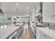 Open concept kitchen features a large island with a sink, stainless steel appliances, and a view to the living room at 10095 S Shadow Hill Dr, Lone Tree, CO 80124