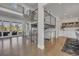 Bright living room with modern staircase, hardwood floors, and large glass doors to outdoor space at 10095 S Shadow Hill Dr, Lone Tree, CO 80124