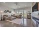 Bright living room with a large sectional sofa, fireplace, and wall decor with many windows at 10095 S Shadow Hill Dr, Lone Tree, CO 80124