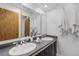 Bright bathroom featuring a double sink vanity with a stone countertop and a large mirror at 1513 S Beech St, Lakewood, CO 80228