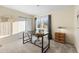 Well-lit bedroom with a minimalist black desk and a large sunny window with grey curtains at 1513 S Beech St, Lakewood, CO 80228