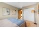 Cozy bedroom with light walls, a stylish lamp, and closet with sliding doors, offering a peaceful retreat at 1513 S Beech St, Lakewood, CO 80228