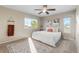 Cozy bedroom featuring neutral paint, carpet flooring, and a large window at 1513 S Beech St, Lakewood, CO 80228