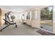 Well-lit exercise room with multiple windows and backyard access at 1513 S Beech St, Lakewood, CO 80228