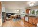 Open concept eat-in kitchen with hardwood floors and view to a cozy sunken living room at 1513 S Beech St, Lakewood, CO 80228