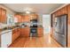 Well-lit kitchen featuring stainless steel appliances, granite countertops, and hardwood floors at 1513 S Beech St, Lakewood, CO 80228