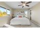 Inviting bedroom features a ceiling fan and two windows offering a picturesque view at 1513 S Beech St, Lakewood, CO 80228