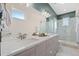 Sleek bathroom with double vanities, a glass-enclosed shower, and modern fixtures at 1625 King St # 4, Denver, CO 80204