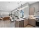 Modern kitchen and living area with stainless steel appliances and light wood cabinets at 1625 King St # 4, Denver, CO 80204