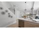 Modern kitchen next to the living room with stainless steel appliances and a large island at 1625 King St # 4, Denver, CO 80204