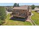 An aerial view showcases the backyard deck, patio, and manicured lawn at 6279 Cheyenne Ct, Parker, CO 80134