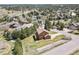 An aerial view of a home with lush landscaping, and nestled within a treed community at 6279 Cheyenne Ct, Parker, CO 80134