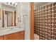 Neutral bathroom featuring a single sink vanity, and a shower/tub with a patterned curtain at 6279 Cheyenne Ct, Parker, CO 80134