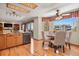 Bright dining area featuring wood floors, bay window, and seamless access to the outdoor deck at 6279 Cheyenne Ct, Parker, CO 80134
