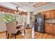 Inviting dining area with wood floors, large bay window, and modern stainless steel refrigerator at 6279 Cheyenne Ct, Parker, CO 80134