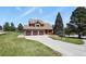 Beautiful home featuring a spacious driveway, well-maintained lawn, and mature trees at 6279 Cheyenne Ct, Parker, CO 80134