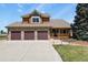 Charming two-story home with a three-car garage, covered porch, and manicured front lawn at 6279 Cheyenne Ct, Parker, CO 80134