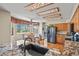 Charming kitchen with granite countertops, stainless appliances, wood cabinetry and a dining area at 6279 Cheyenne Ct, Parker, CO 80134