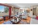 Well-lit living room with hardwood floors, an outdoor view, and an open layout leading to the kitchen at 6279 Cheyenne Ct, Parker, CO 80134