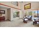 Bright living room with high ceilings, large windows, and a view of the dining area at 6279 Cheyenne Ct, Parker, CO 80134