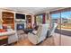 Cozy living room with a fireplace, built-in bookshelves, and sliding glass doors to the deck at 6279 Cheyenne Ct, Parker, CO 80134