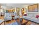 Open-concept living space with hardwood floors, kitchen access, and comfortable seating arrangements at 6279 Cheyenne Ct, Parker, CO 80134