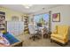 This office area has a large window, decorative shelves, and a comfortable seating area at 6279 Cheyenne Ct, Parker, CO 80134