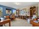 The home office is equipped with built-in bookshelves and lots of natural light at 6279 Cheyenne Ct, Parker, CO 80134