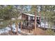 Aerial view of a two-story home with a deck and mountain views at 723 Eaton Rd, Palmer Lake, CO 80133