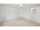 Clean bedroom featuring neutral carpeting, fresh paint, and a door leading to other rooms at 723 Eaton Rd, Palmer Lake, CO 80133