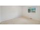 Bright bedroom featuring fresh white walls, neutral carpet, and a large window at 723 Eaton Rd, Palmer Lake, CO 80133