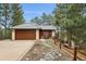 Charming home featuring a tile roof, stone accents, and a convenient attached two-car garage at 723 Eaton Rd, Palmer Lake, CO 80133