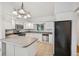 Bright white kitchen with stainless steel appliances, tile flooring, and a spacious layout at 723 Eaton Rd, Palmer Lake, CO 80133