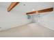 Bright living room with wood beam accents, neutral carpet, and fresh white paint at 723 Eaton Rd, Palmer Lake, CO 80133