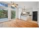 Open-concept living and dining areas feature hardwood floors and large windows with views at 723 Eaton Rd, Palmer Lake, CO 80133