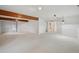 Spacious living room with neutral carpet and fresh white paint leads to other rooms at 723 Eaton Rd, Palmer Lake, CO 80133