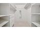 Large walk-in closet featuring a built-in shelving system with fresh white paint at 723 Eaton Rd, Palmer Lake, CO 80133