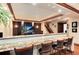 Basement bar featuring a granite countertop, barstool seating, and a large TV at 479 Blue Lake Trl, Lafayette, CO 80026