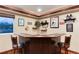 Finished basement bar featuring barstool seating, decorative shelving, and a scenic window view at 479 Blue Lake Trl, Lafayette, CO 80026