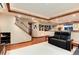 Finished basement with staircase, hardwood floors, comfortable seating, and ample lighting at 479 Blue Lake Trl, Lafayette, CO 80026