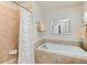 Bathroom with a tiled jacuzzi bathtub, shower, and a large decorative mirror at 479 Blue Lake Trl, Lafayette, CO 80026