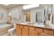Bathroom with double sinks, tile floors, and a separate bathtub and toilet area at 479 Blue Lake Trl, Lafayette, CO 80026